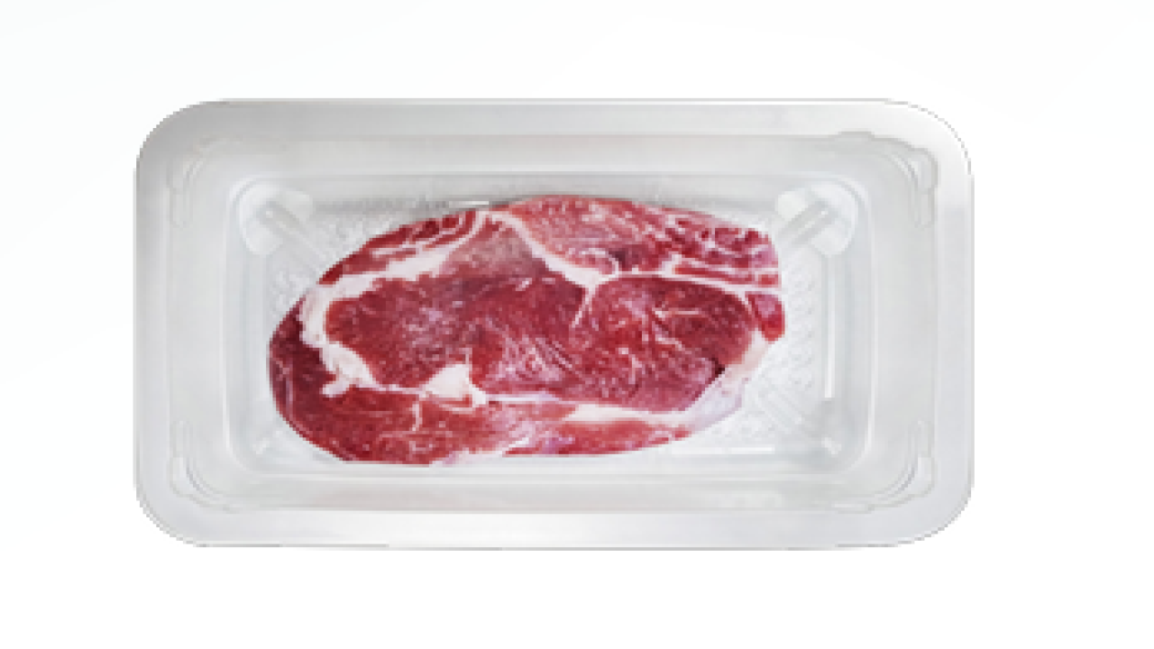 A cut of meat in a clear sealed package.