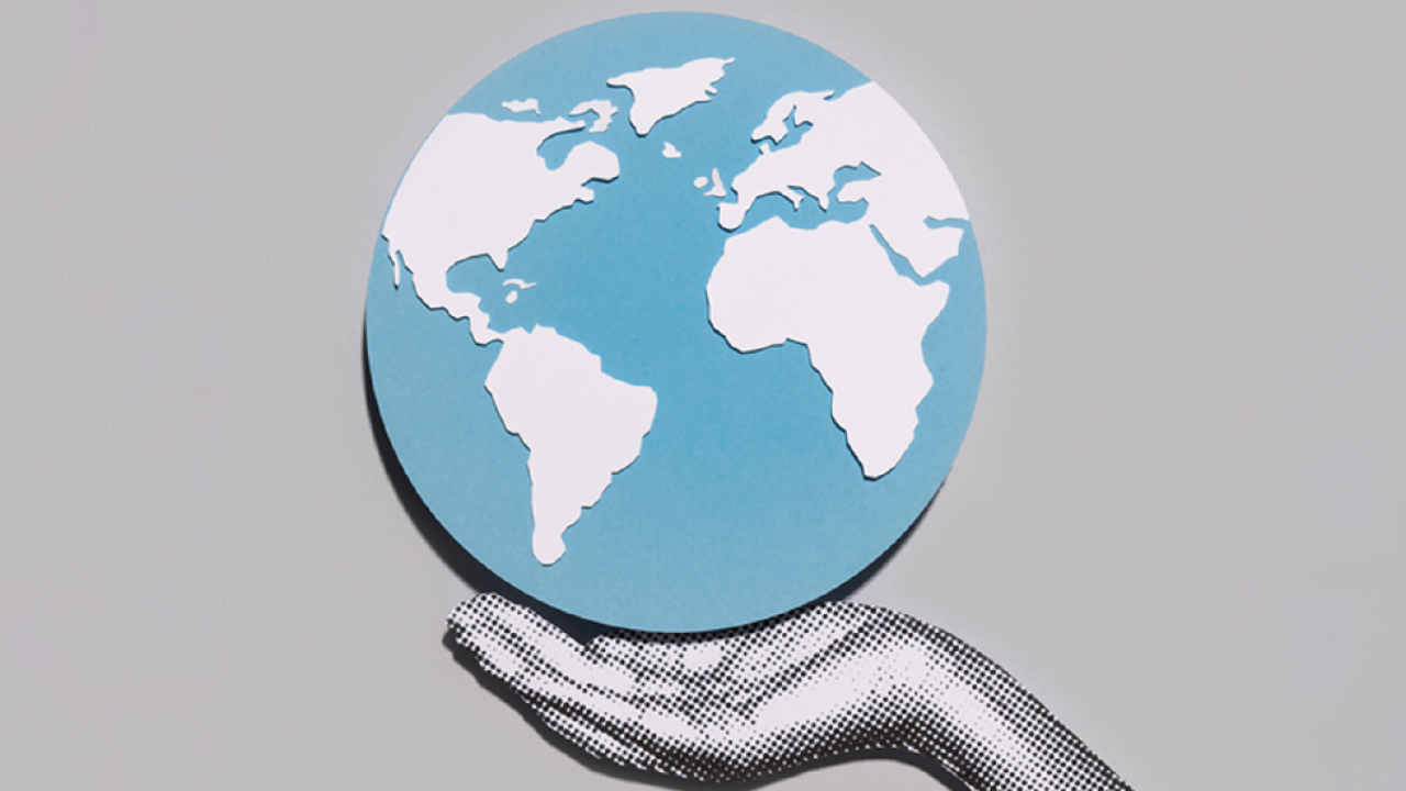Hand holding a globe