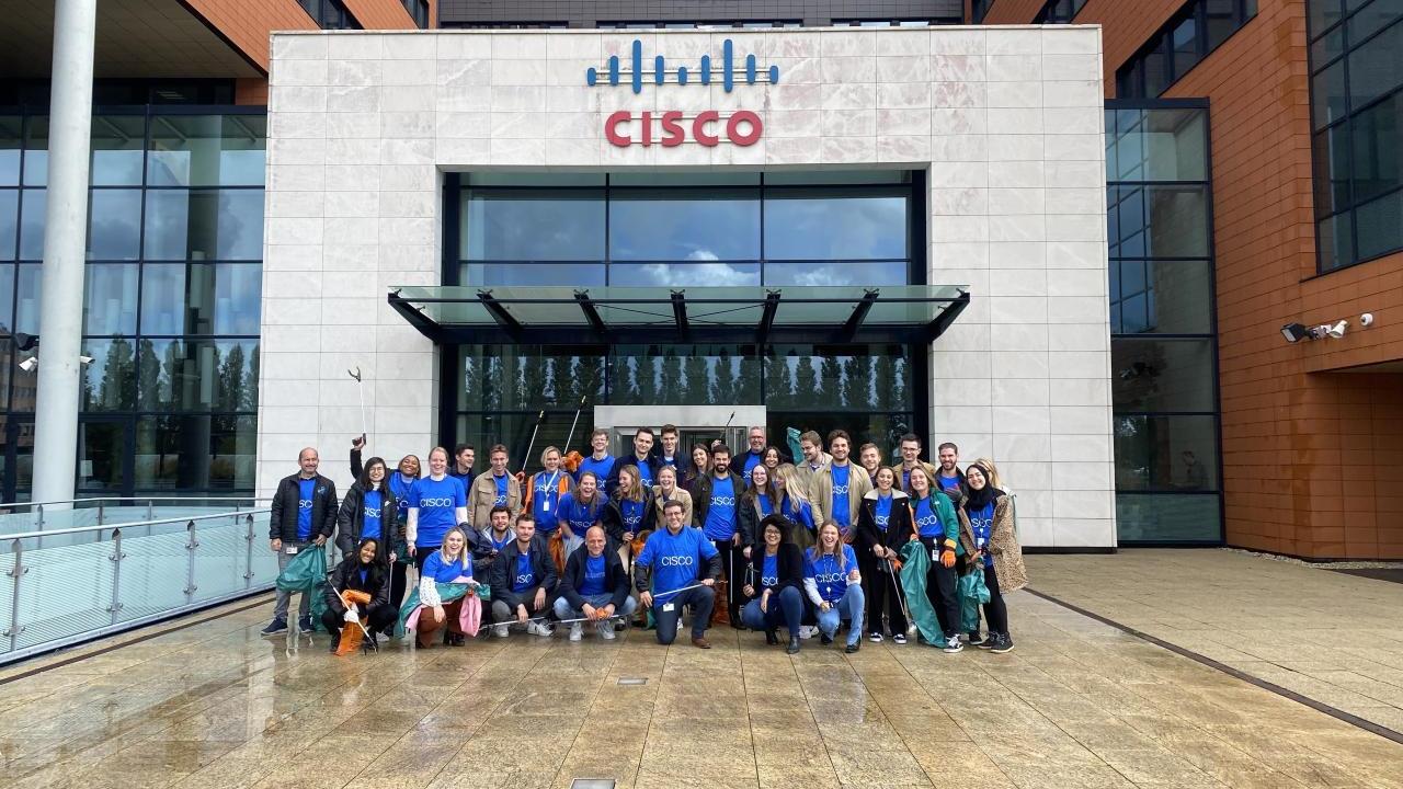 A group of volunteers posed outside an office building