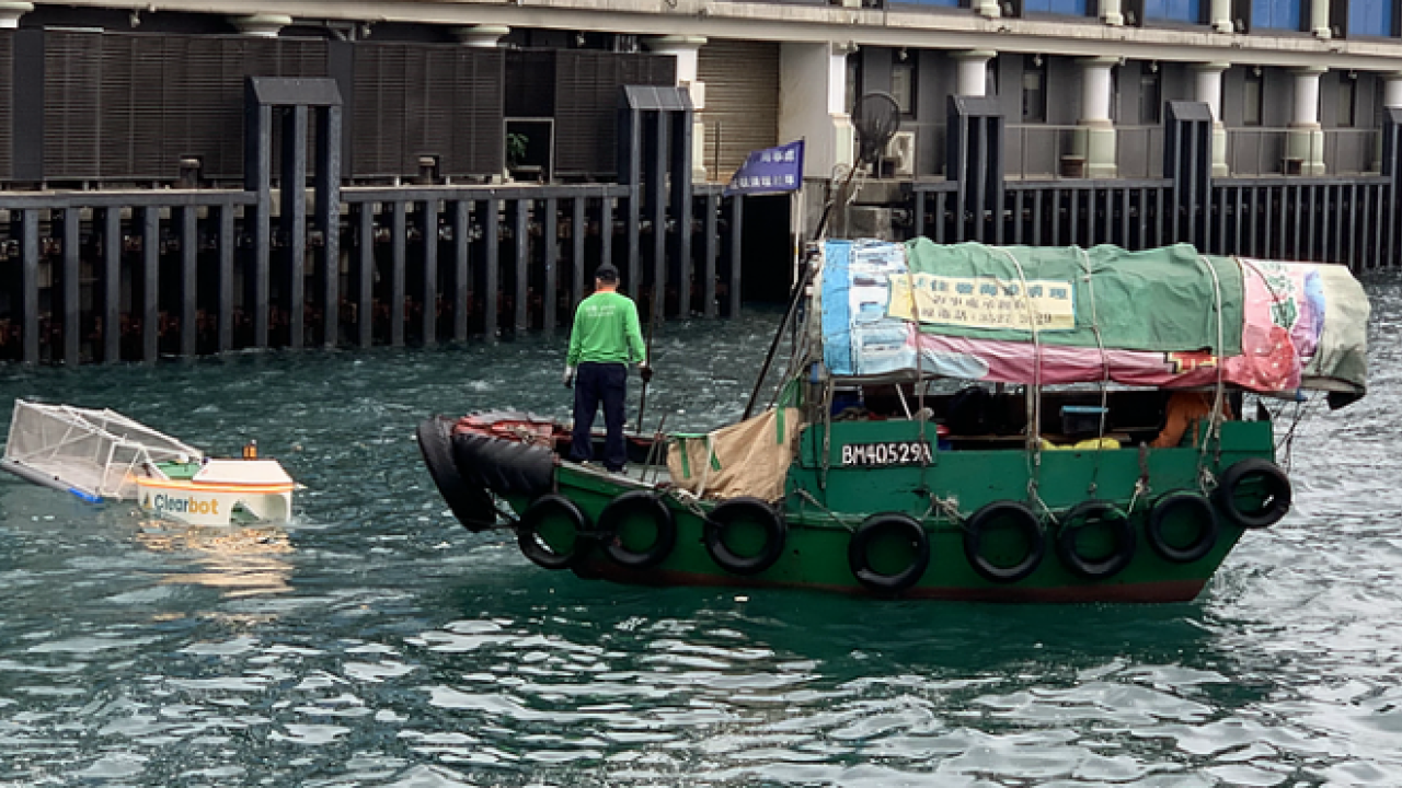 Clearbot (left) and small boat on a river
