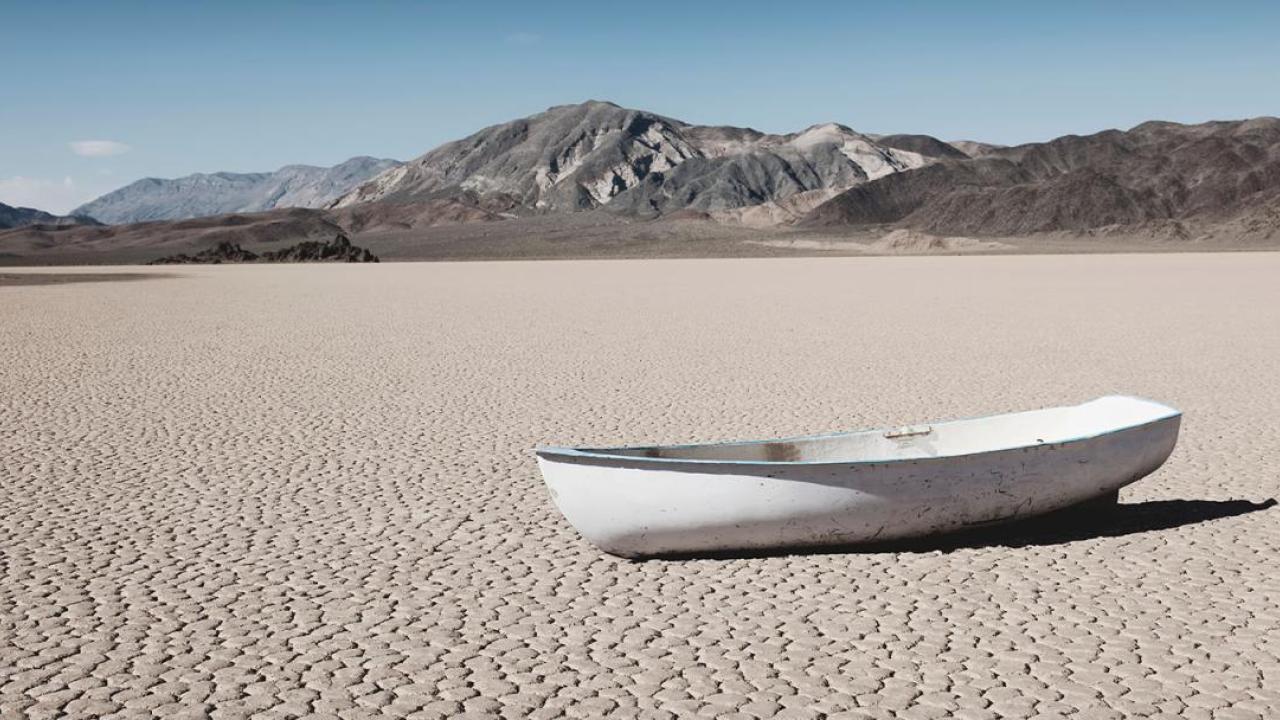 A small boat in a barren desert landscape.