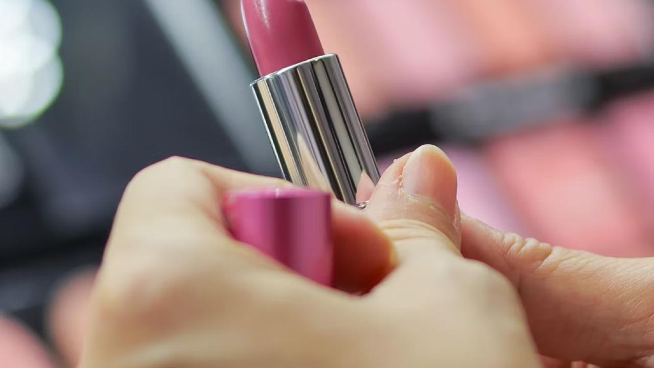 Close up of a hand holding a lipstick 