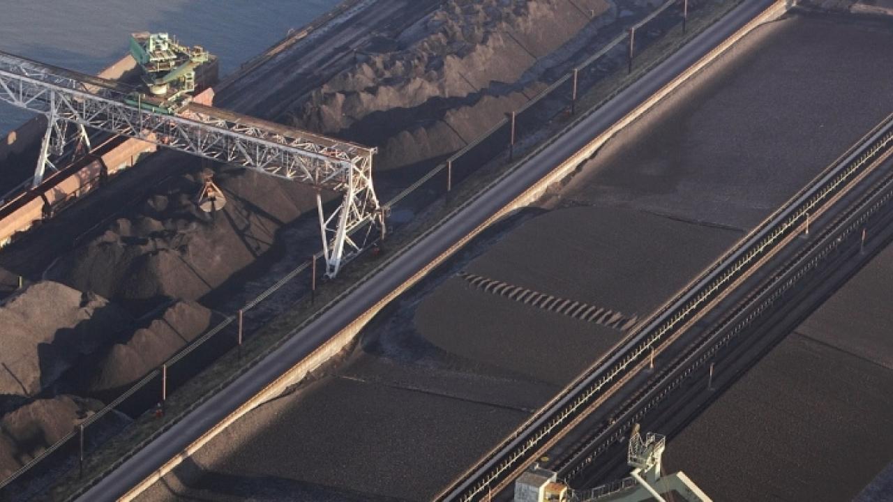 aerial view of huge transport barges being filled with possibly coal. 