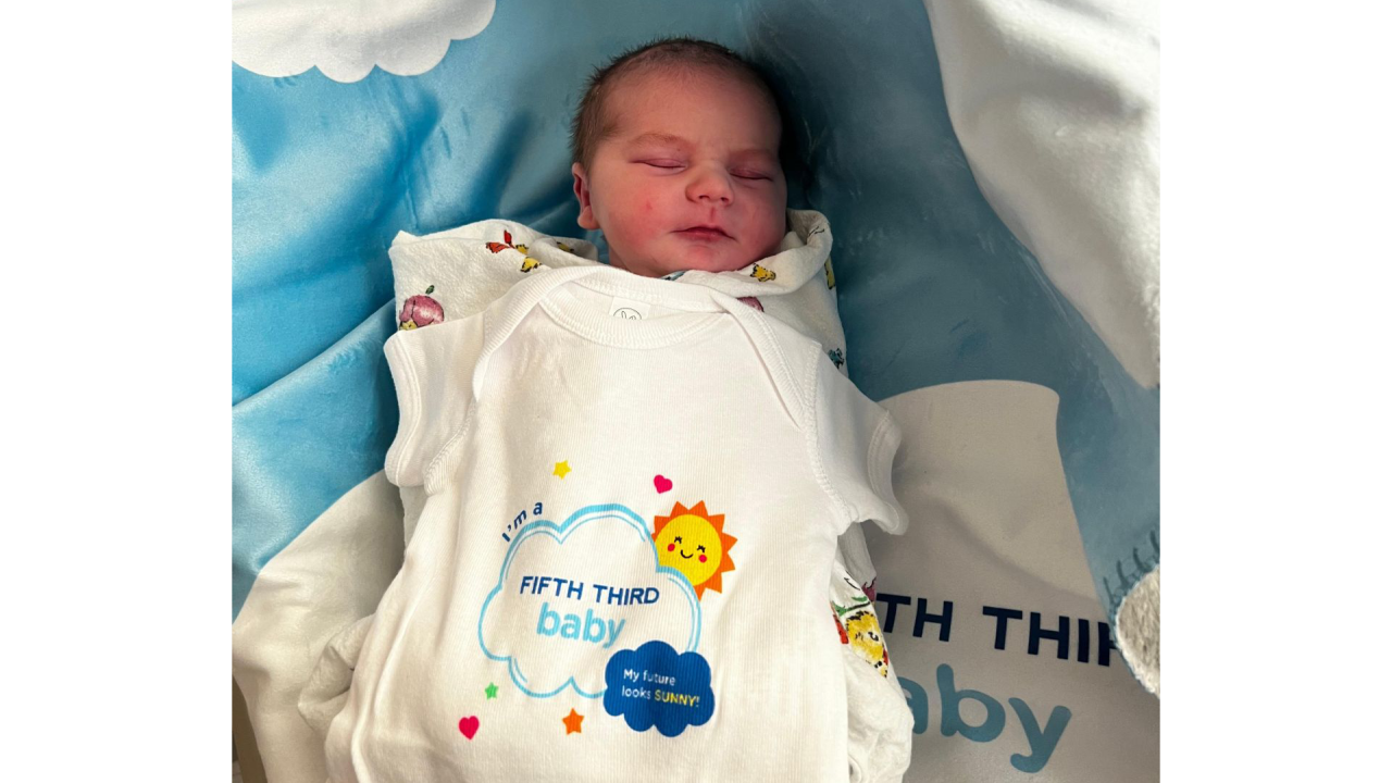 baby in an "I'm a Fifth Third Baby" onsie