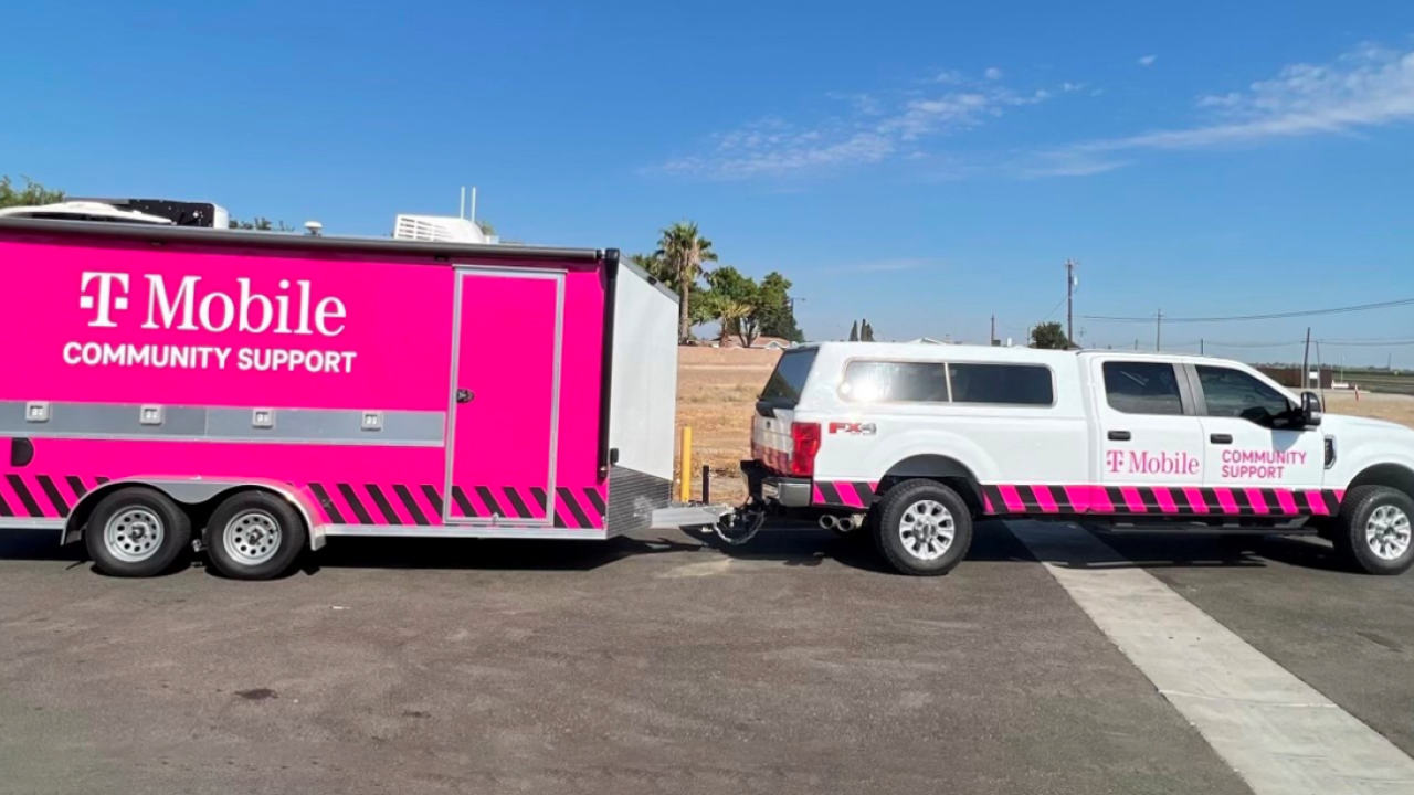 TMobile community support truck and pink trailer on the road