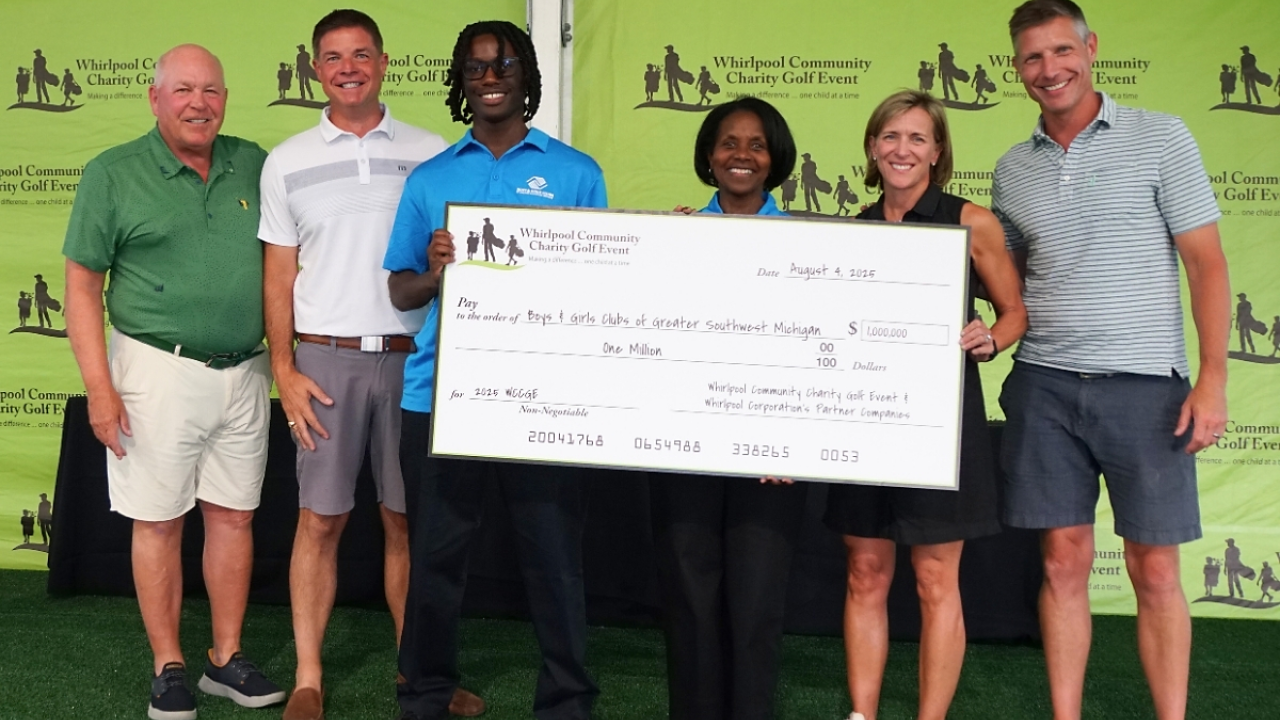 People posing with an oversized check