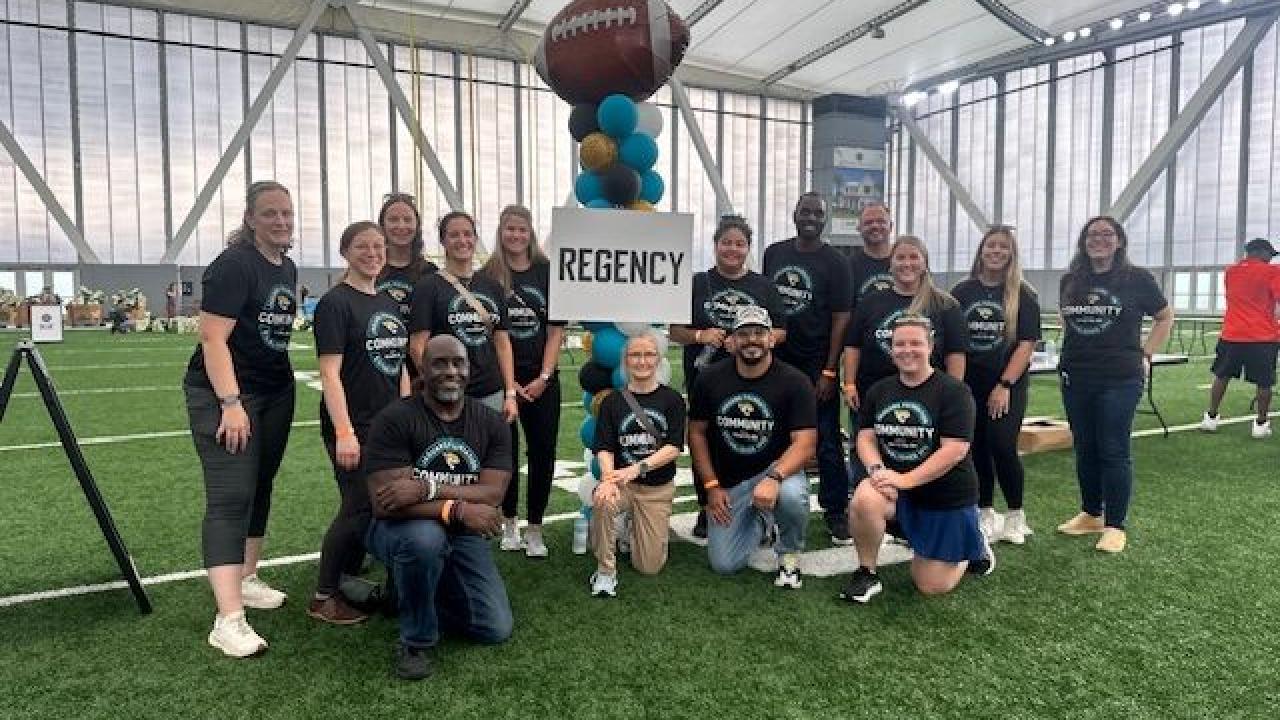 Volunteers posed in an indoor stadium