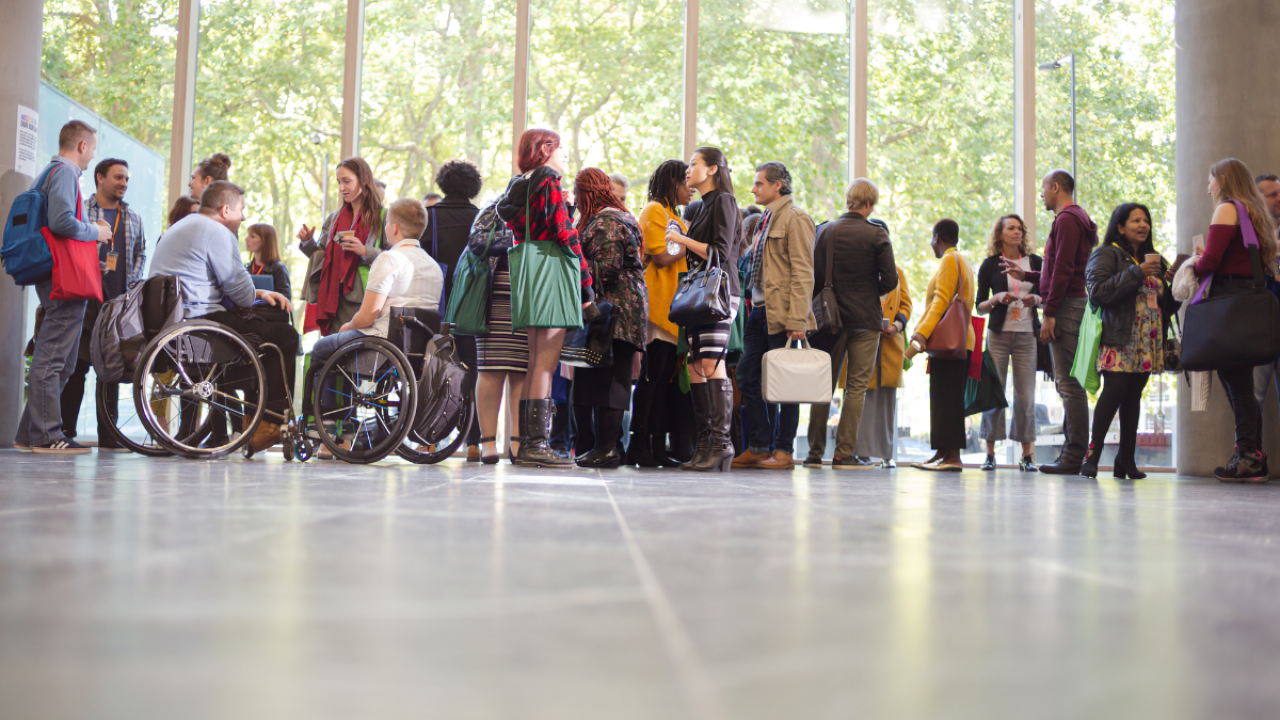 group of people standing together in a large room