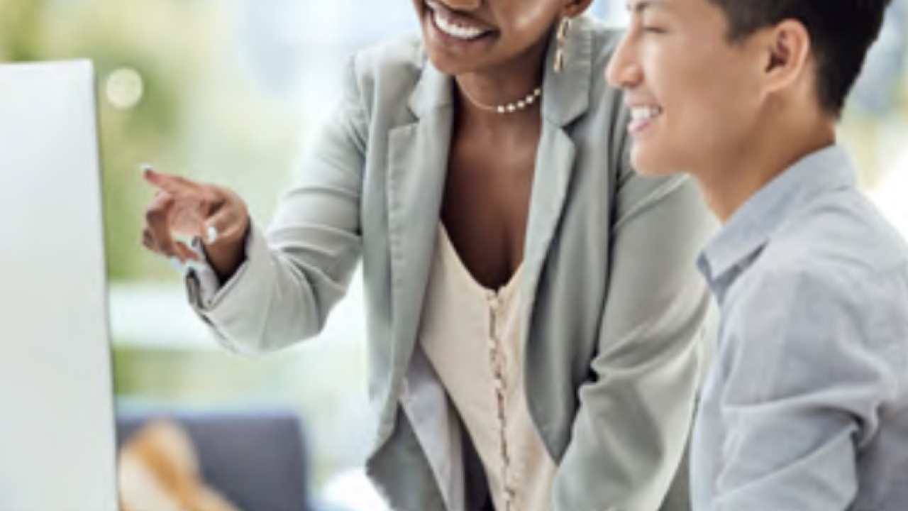 LyondellBasell employees smiling together at computer screen 