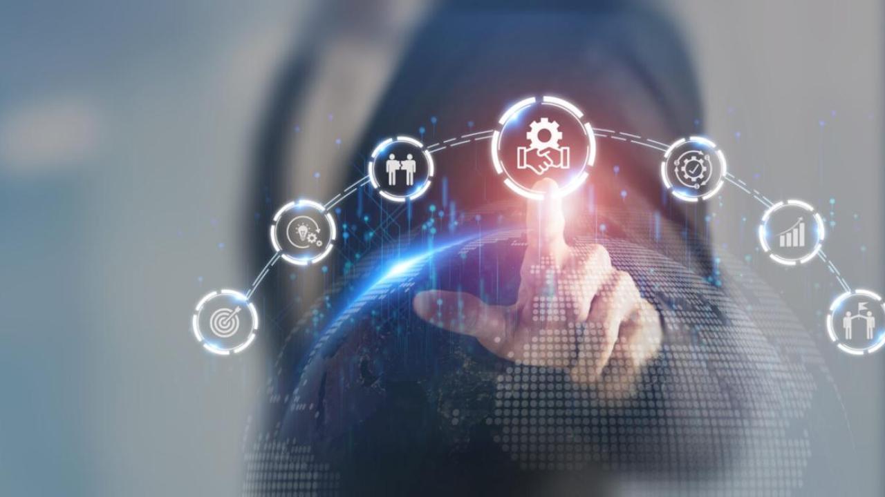 A person pointing to a digital rendering of symbols in an arch connected.