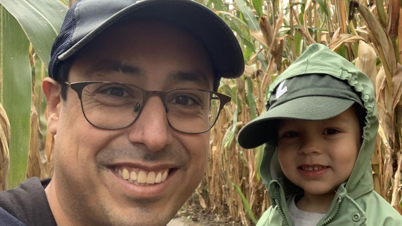 Matthew Sanchez and a child in a corn maze