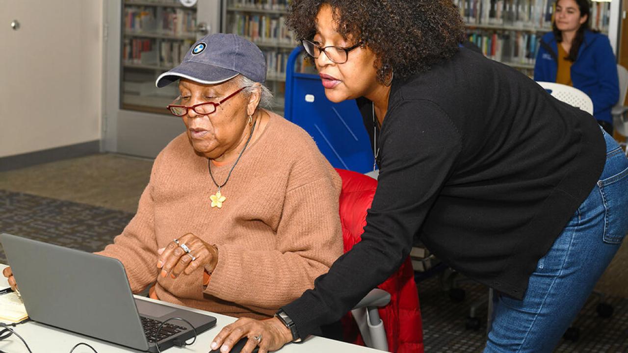 One person teaching another computer skills