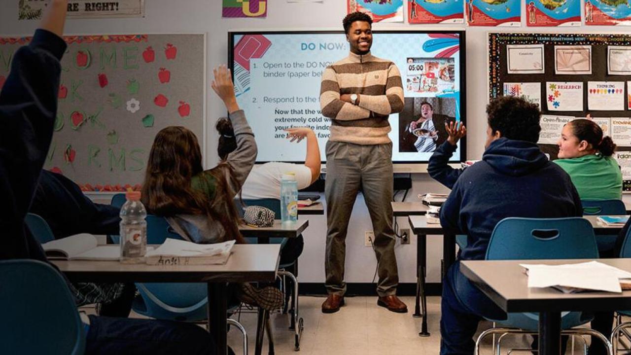A teacher instructs his class of students 