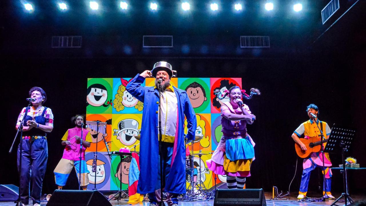 People in brightly colored clothing performing on a stage