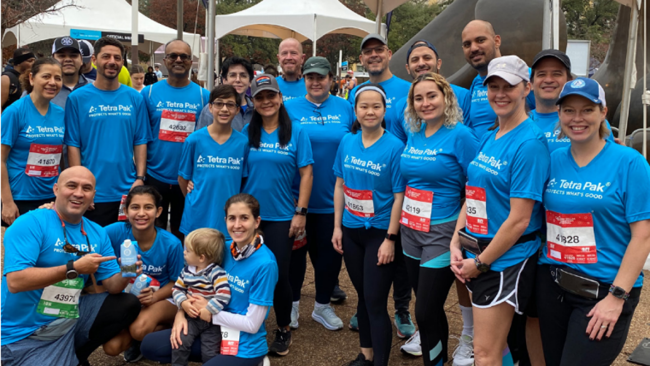 A posed group of runners and fans.