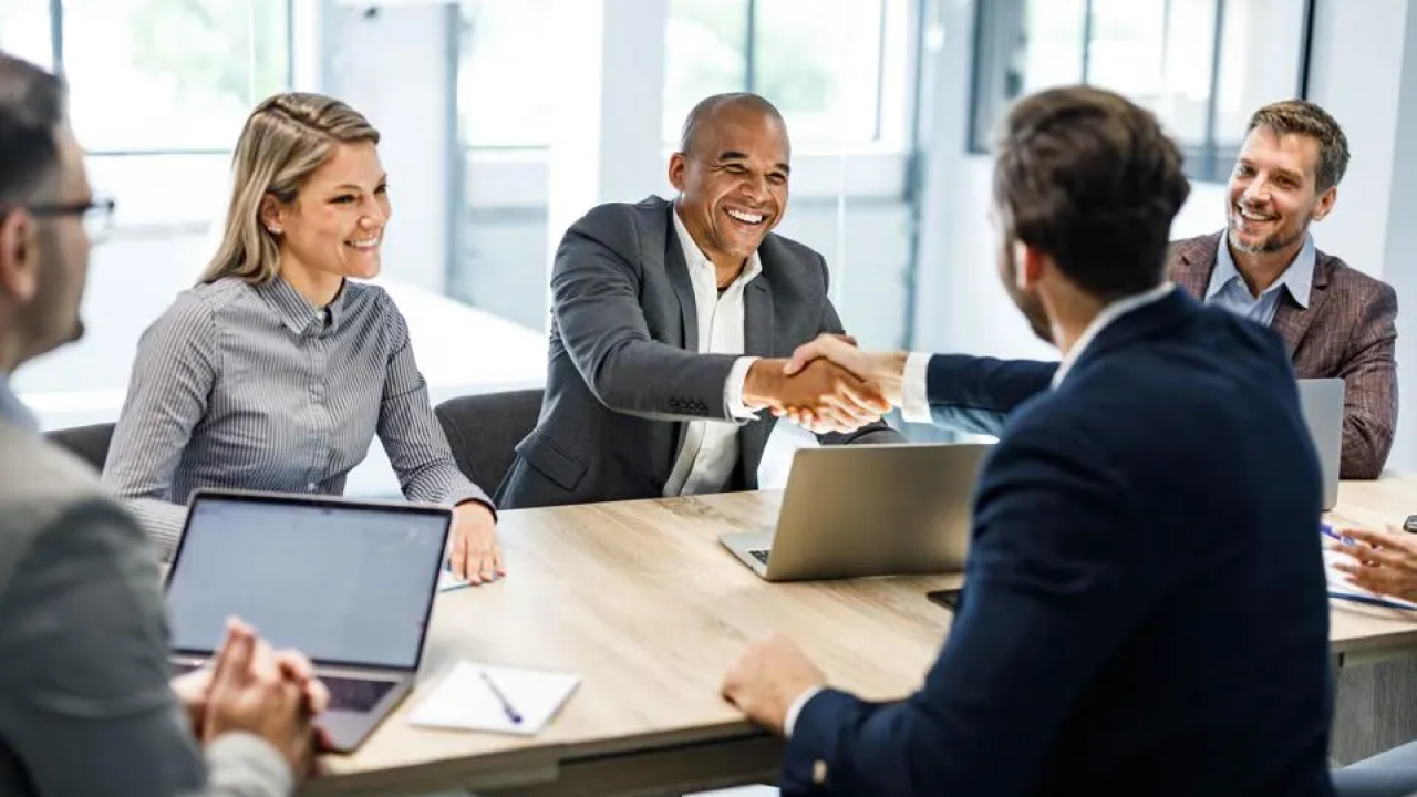 People shaking hands in a meeting