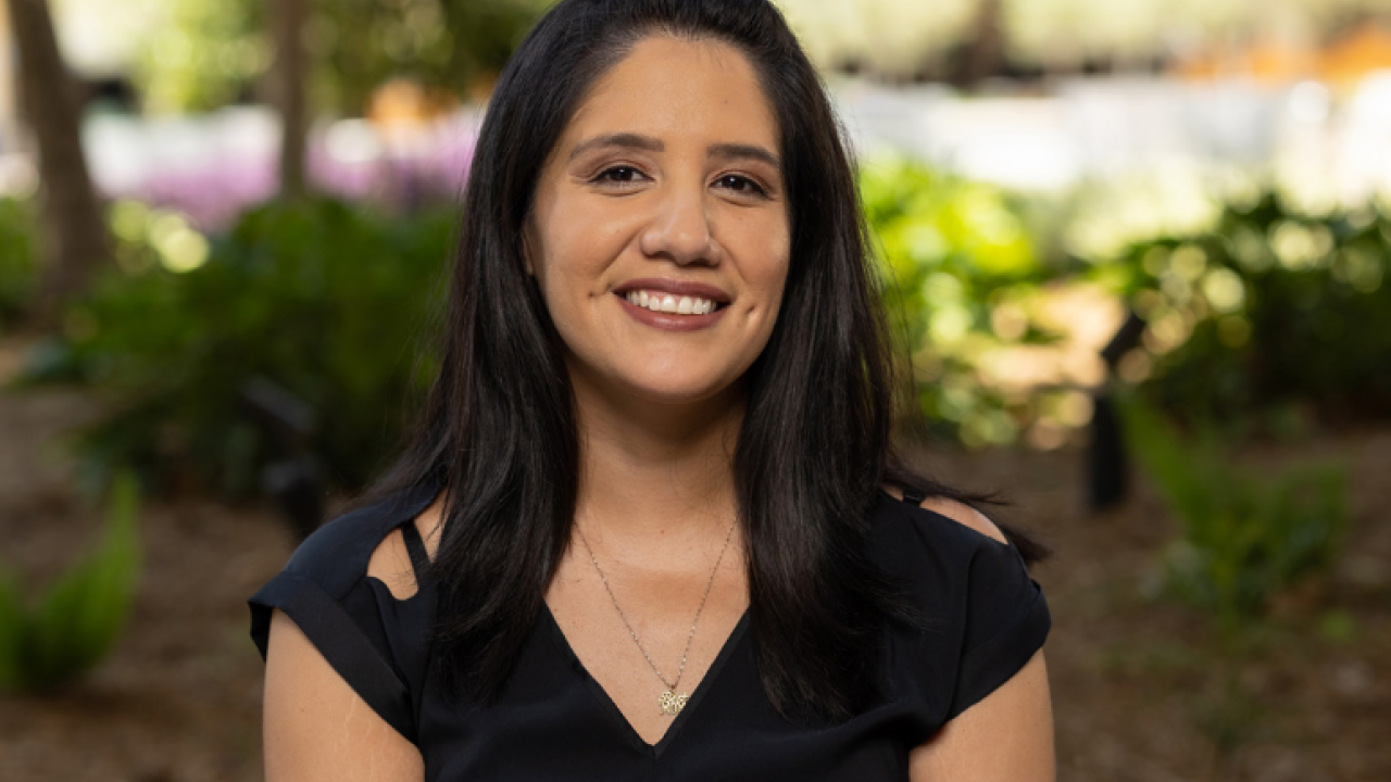 Woman in a black shirt, smiling