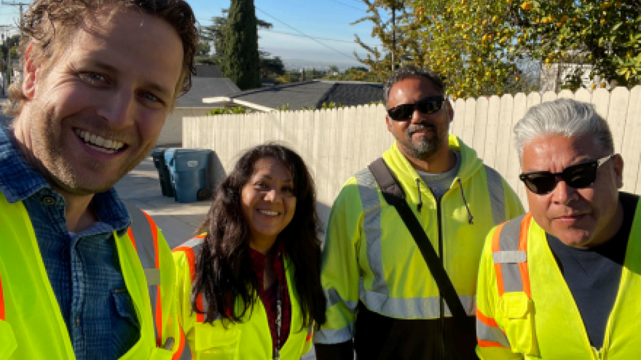 Group of four people in safety vests posed.