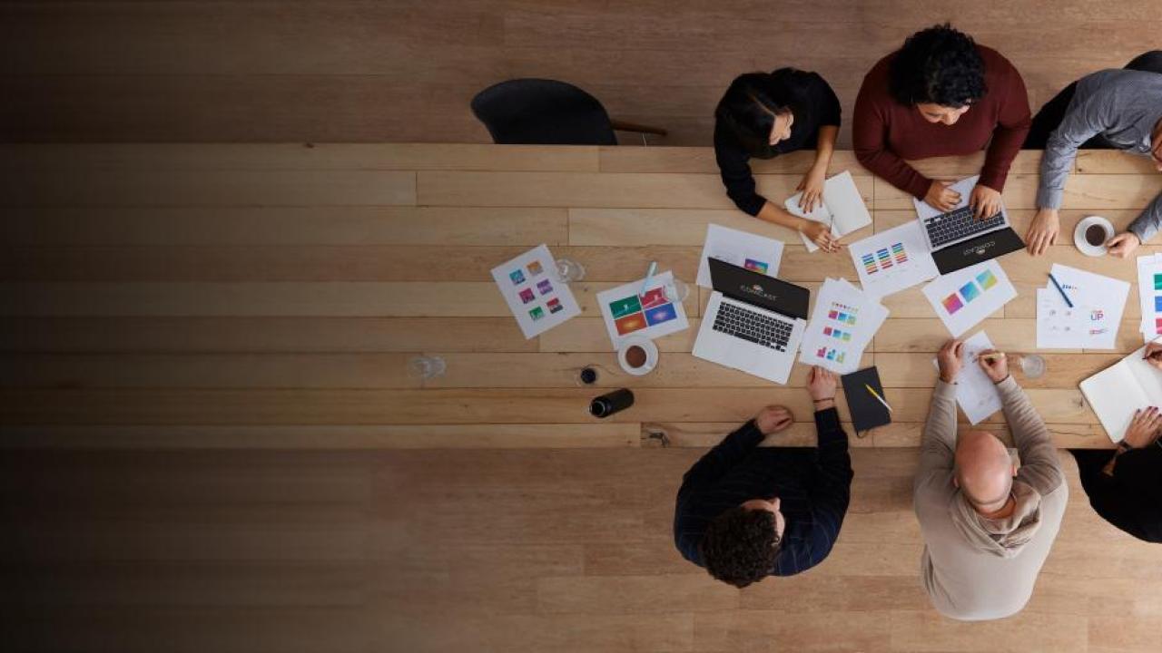 bird's eye view of people working at a desk