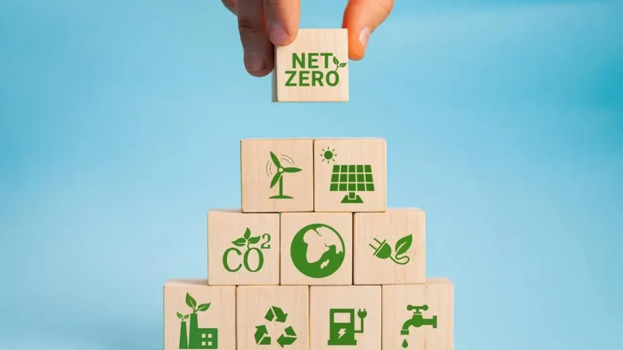 person adding "net-zero" block on top of other blocks