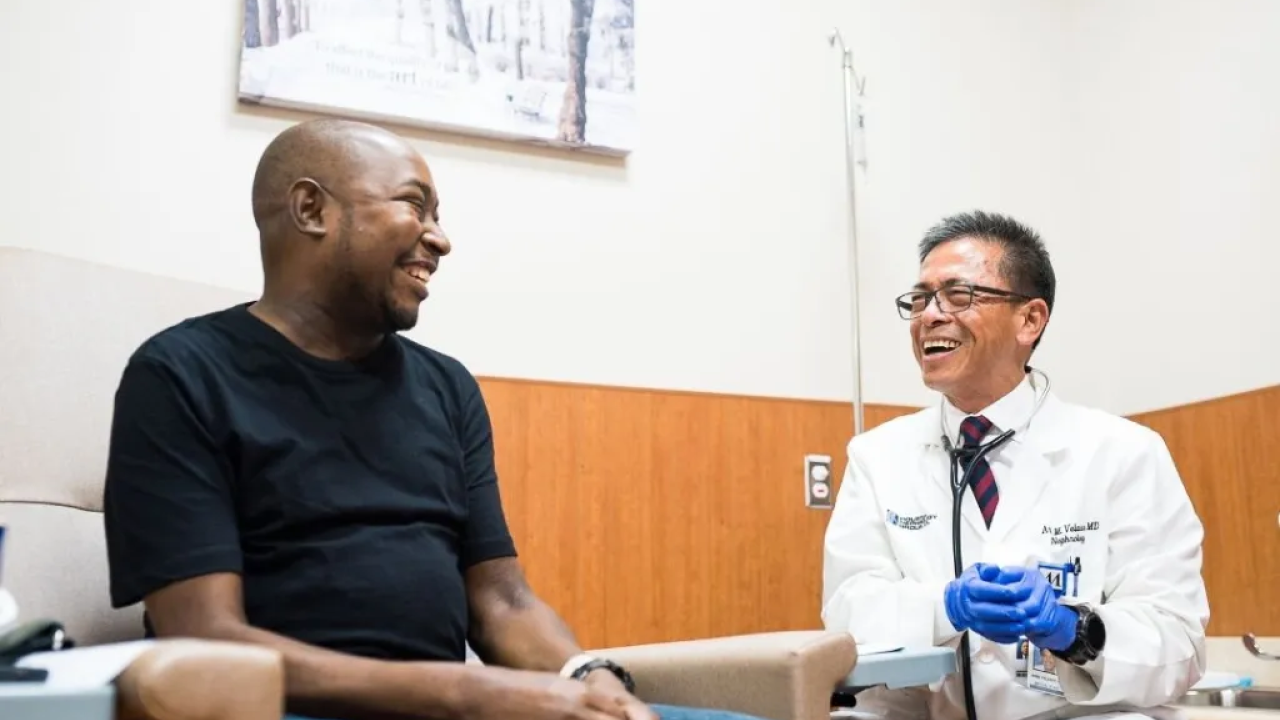Healthcare worker laughing with a patient