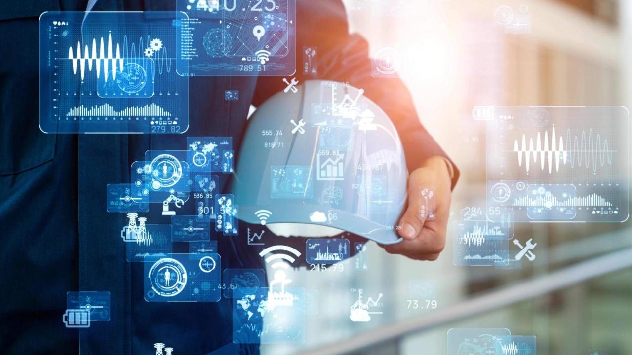 A person holding a hard hat. Digital symbols and images superimposed.