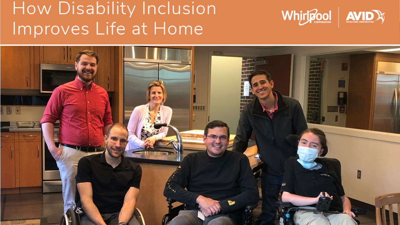 3 people stand behind 3 people in wheelchairs in a home kitchen