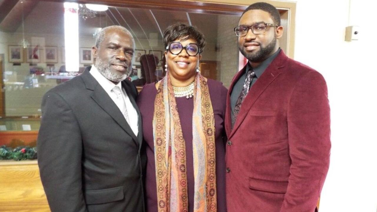 Three people posing and smiling