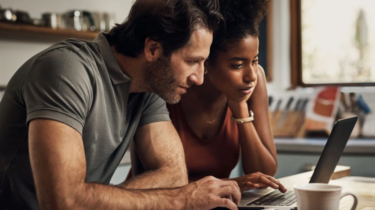 Two people looking at a laptop together