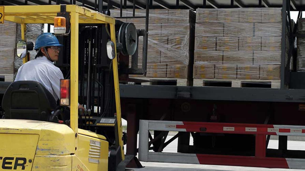 person driving a machine in a warehouse