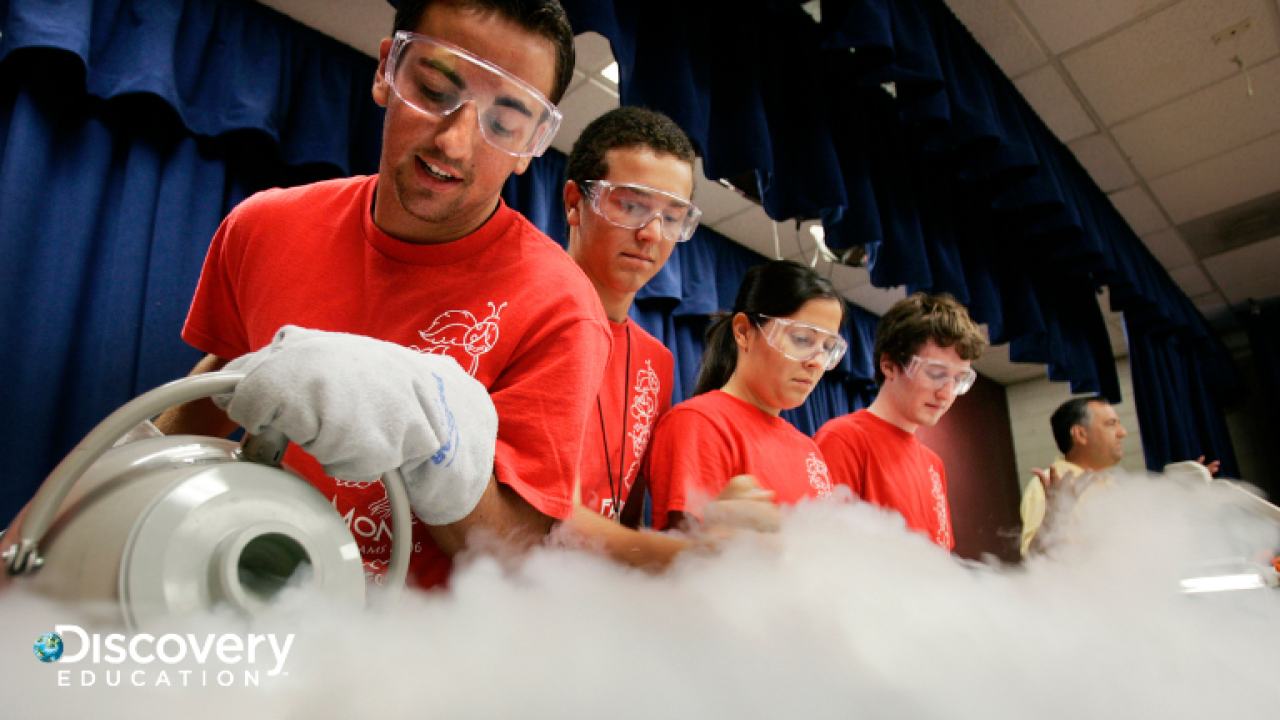 Students in safety glasses working on a project