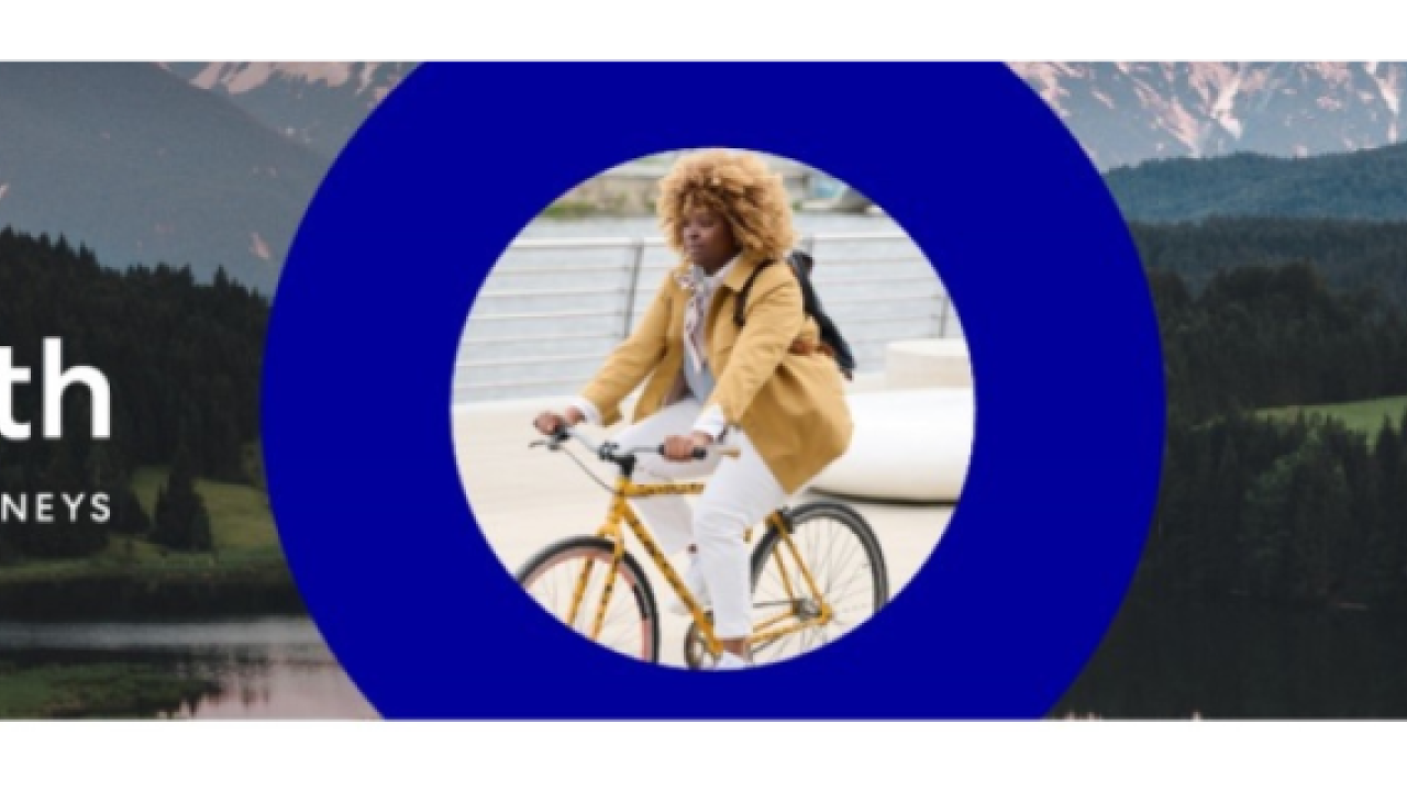 Earth Month, powering sustainable journeys. A person on a bicycle is central.