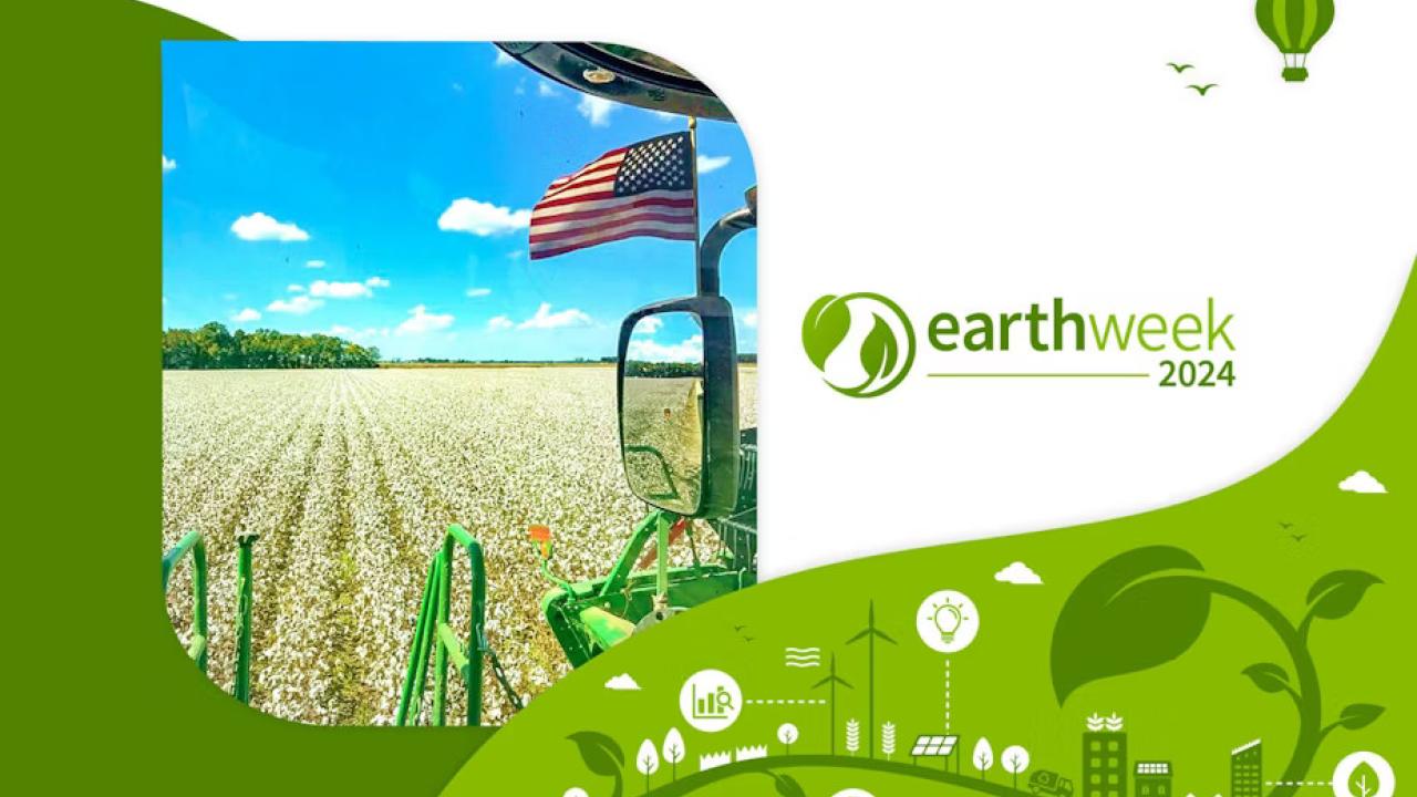 "earth week 2024" next to an american flag on a tractor in a field of crops.