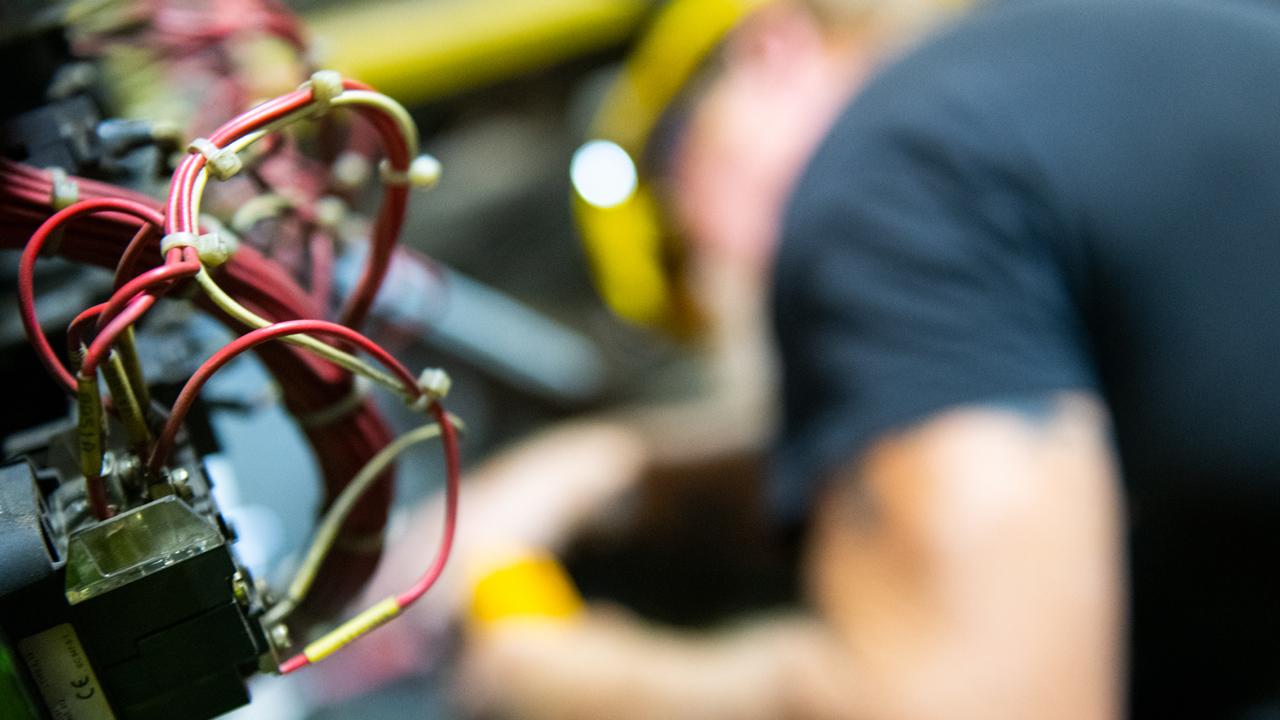 An electrician working, wires in the foreground