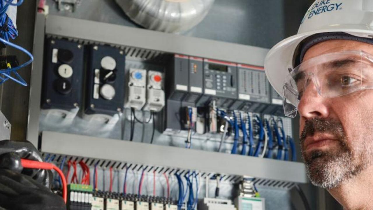 An electrician working with wires and tools.