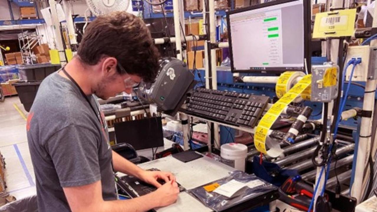 Person working on computer part