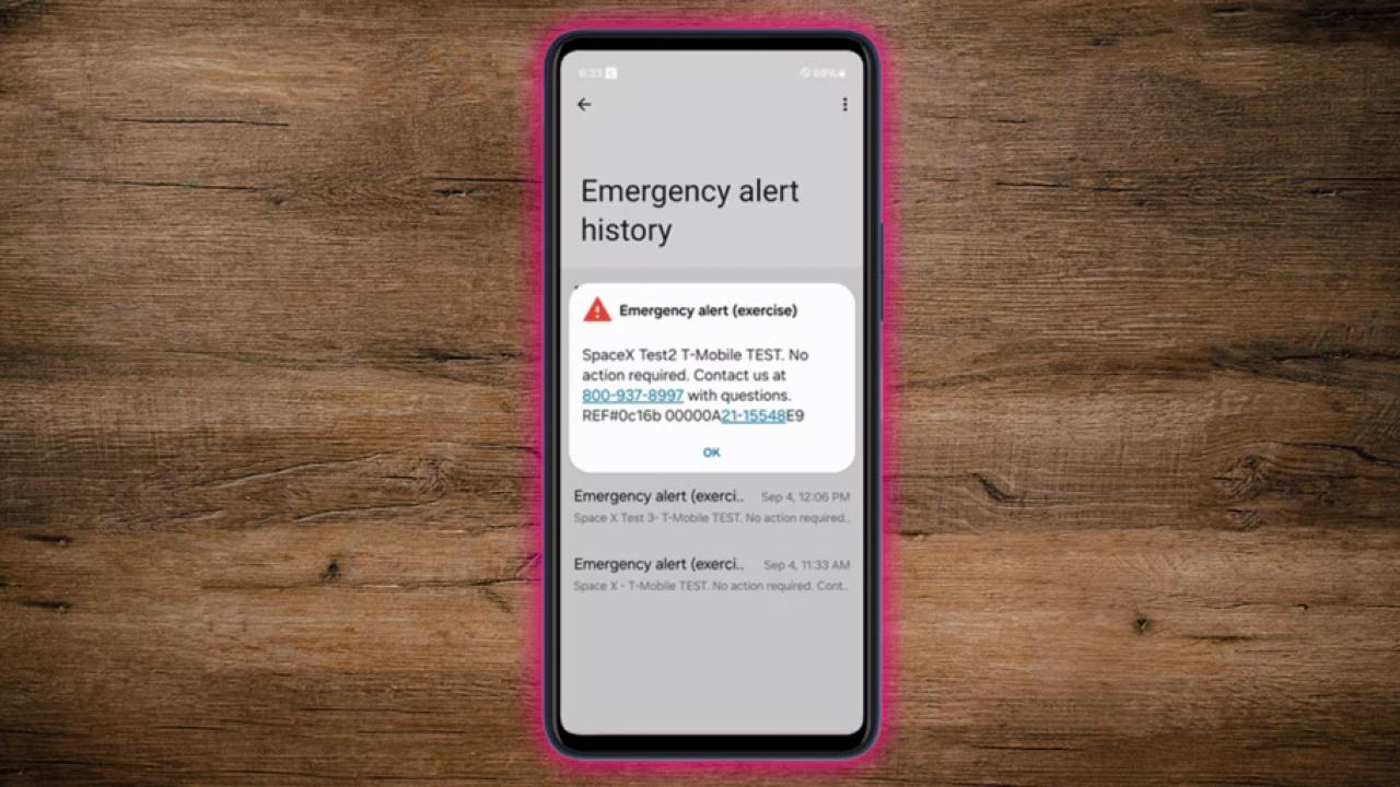 Phone on a wood table displaying an emergency message