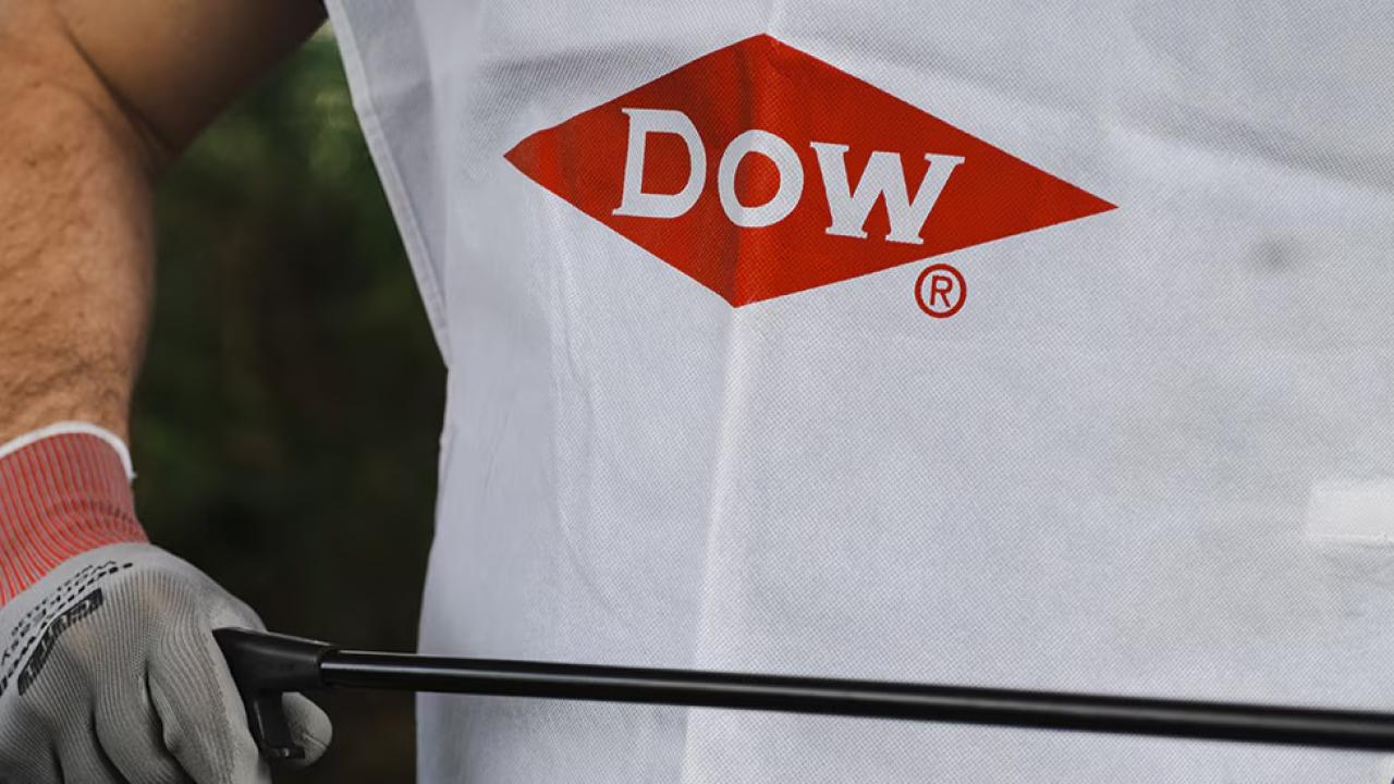 person wearing gloves and a Dow shirt