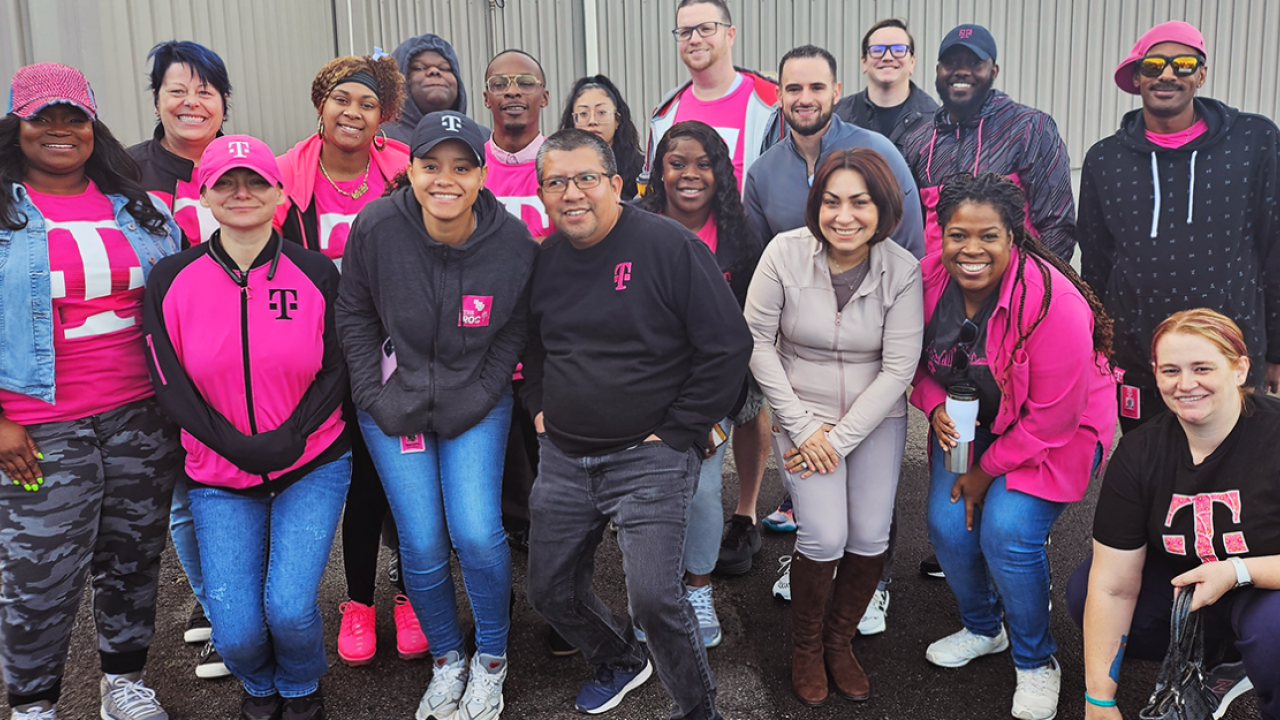 Group of people standing together in T-Mobile branded apparel