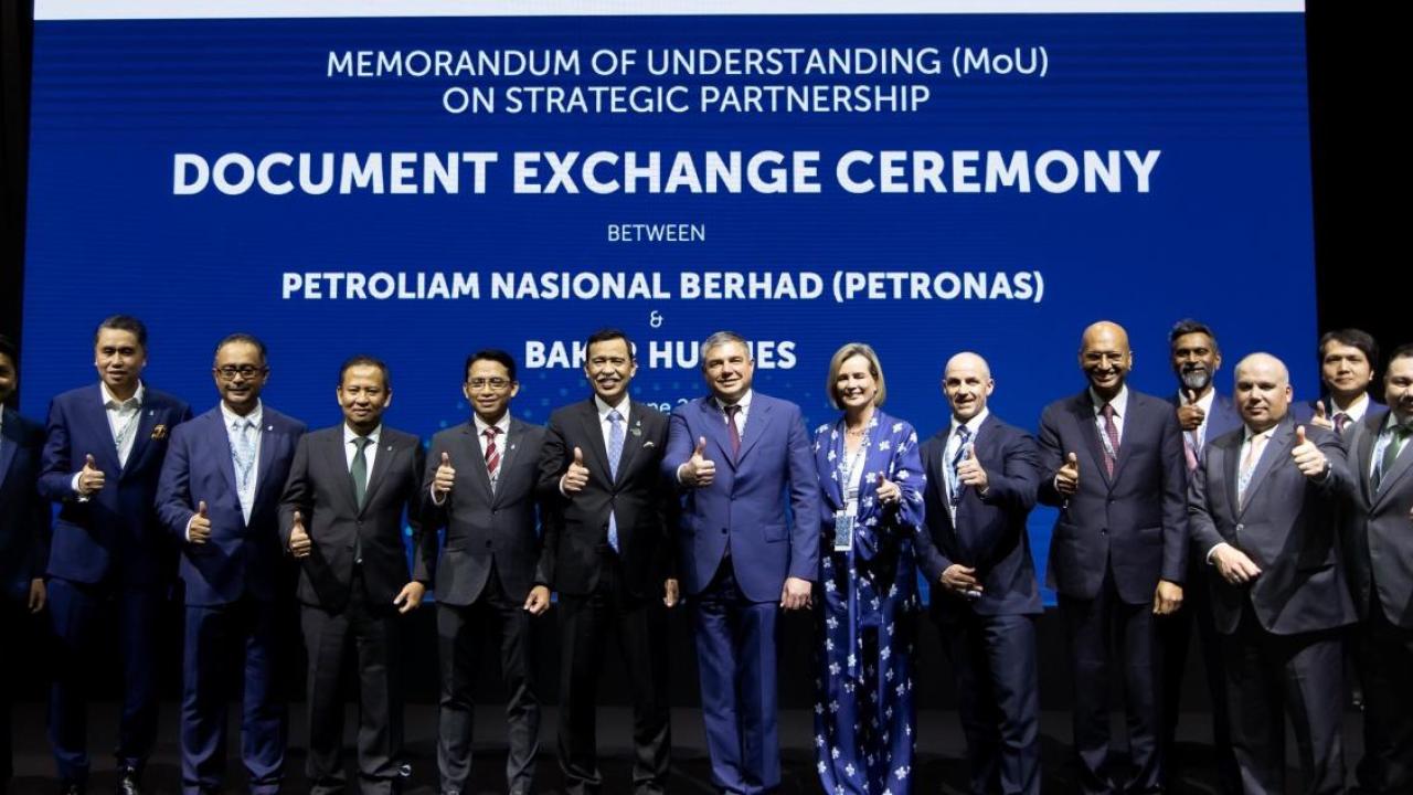 group photo at the Document Exchange Ceremony with participants giving the thumbs up sign