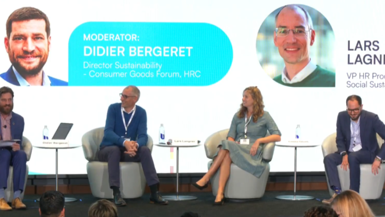 The image features a panel of speakers