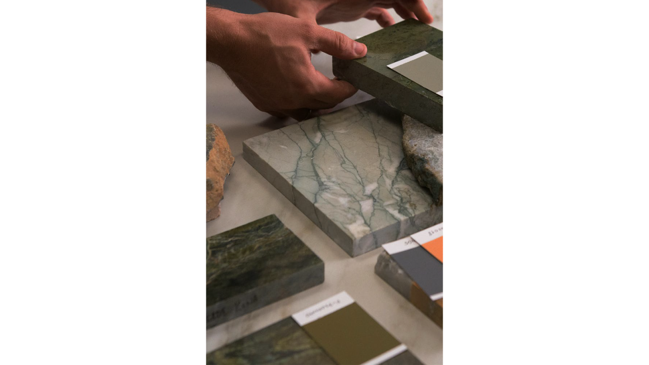 comparing paint swatches with marble material