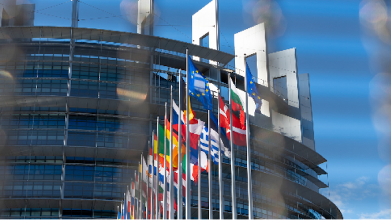 Photo of outside of a building with the flags of EU flying.