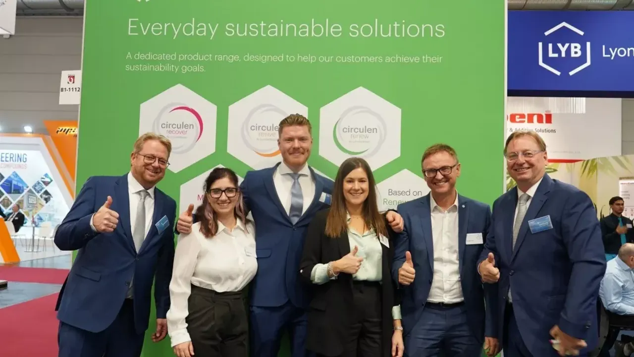 A group of people stood together in front of a LYB event backdrop 