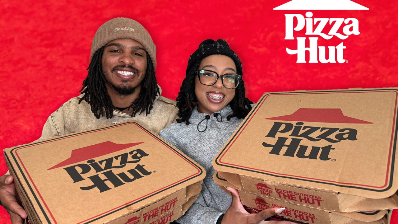 Keith Lee and his wife holding pizza hut boxes
