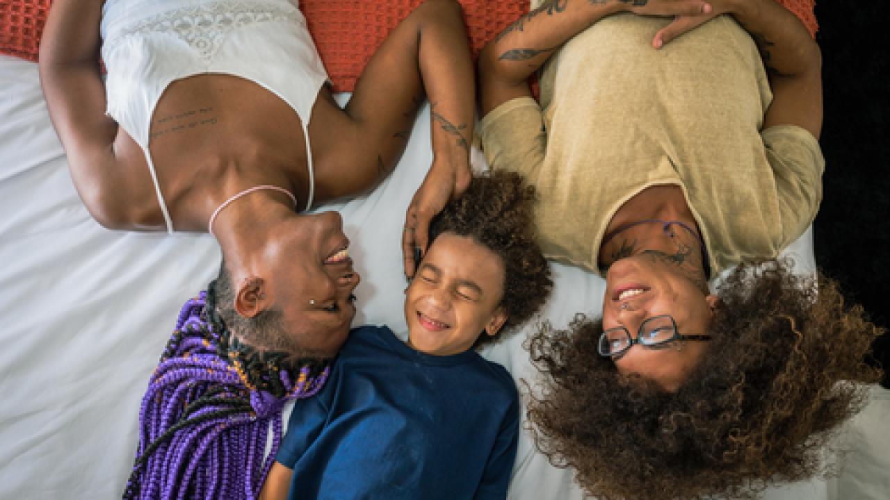 Family laying in bed