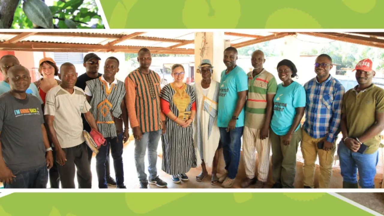 A group of people posed under a canopy.