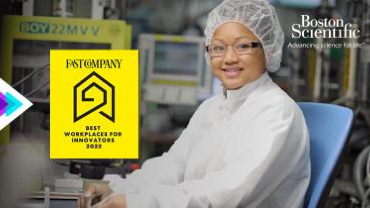 a person seated in lab protective gear, monitors and equipment behind them. "Fast Company" award logo and Boston Scientific logo in upper right corner