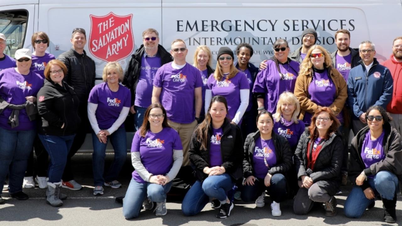 FedEx volunteers in front of a Salvation Army van