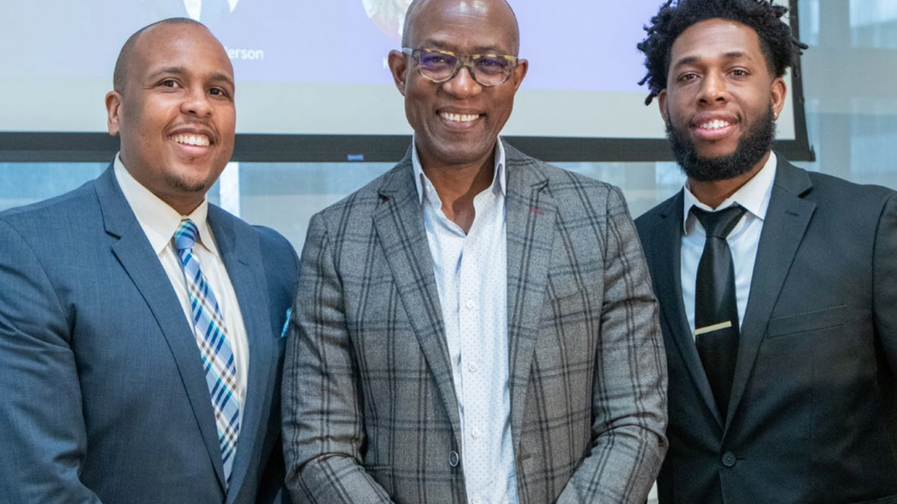 group of three black men in suits smiling